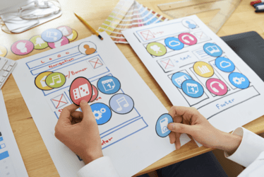 A persons hands piecing together a user journey with cutouts